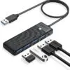 ORICO 4-Port USB 3.0 Hub Four USB ports illuminated with blue LED lights on the ORICO hub