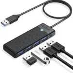 ORICO 4-Port USB 3.0 Hub Four USB ports illuminated with blue LED lights on the ORICO hub