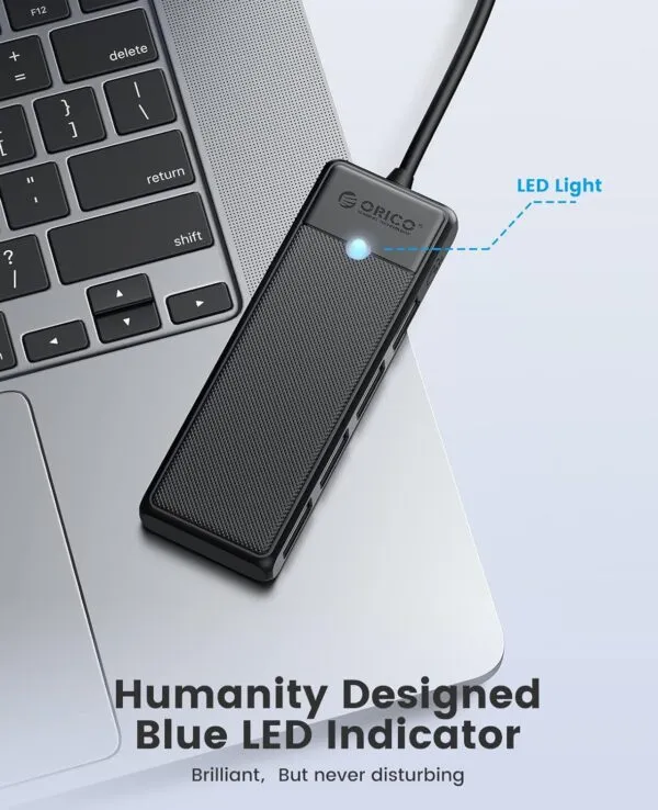 ORICO USB hub surrounded by various devices including a MacBook, iMac, and Surface Pro.