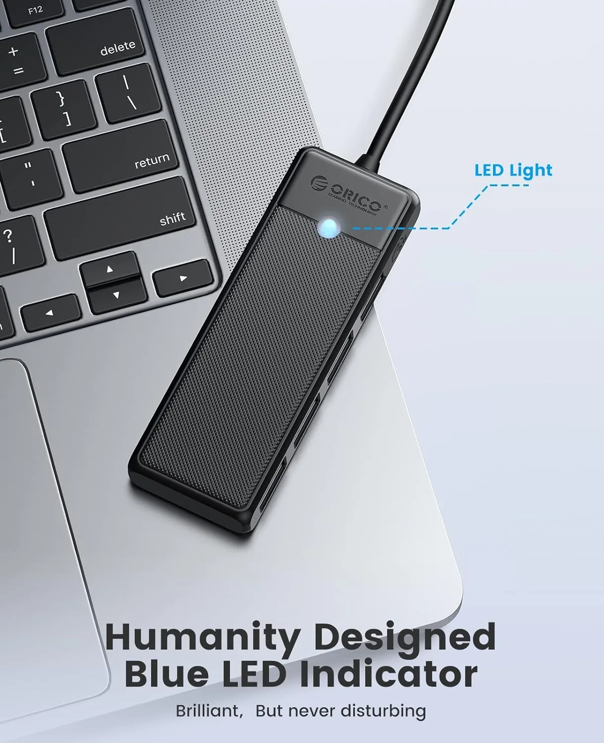 ORICO USB hub surrounded by various devices including a MacBook, iMac, and Surface Pro.