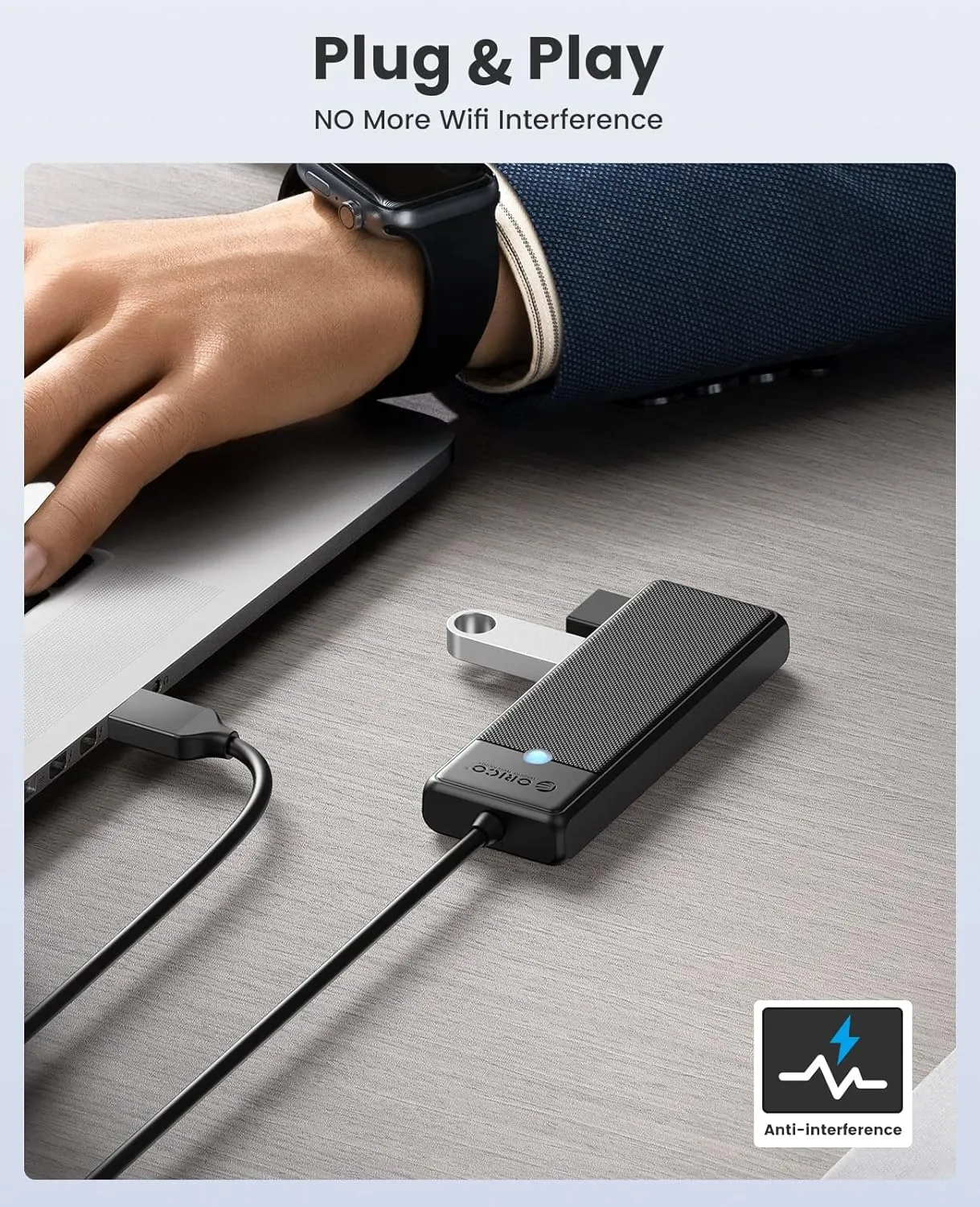 A sleek, silver 4-port USB hub sits on a white surface.